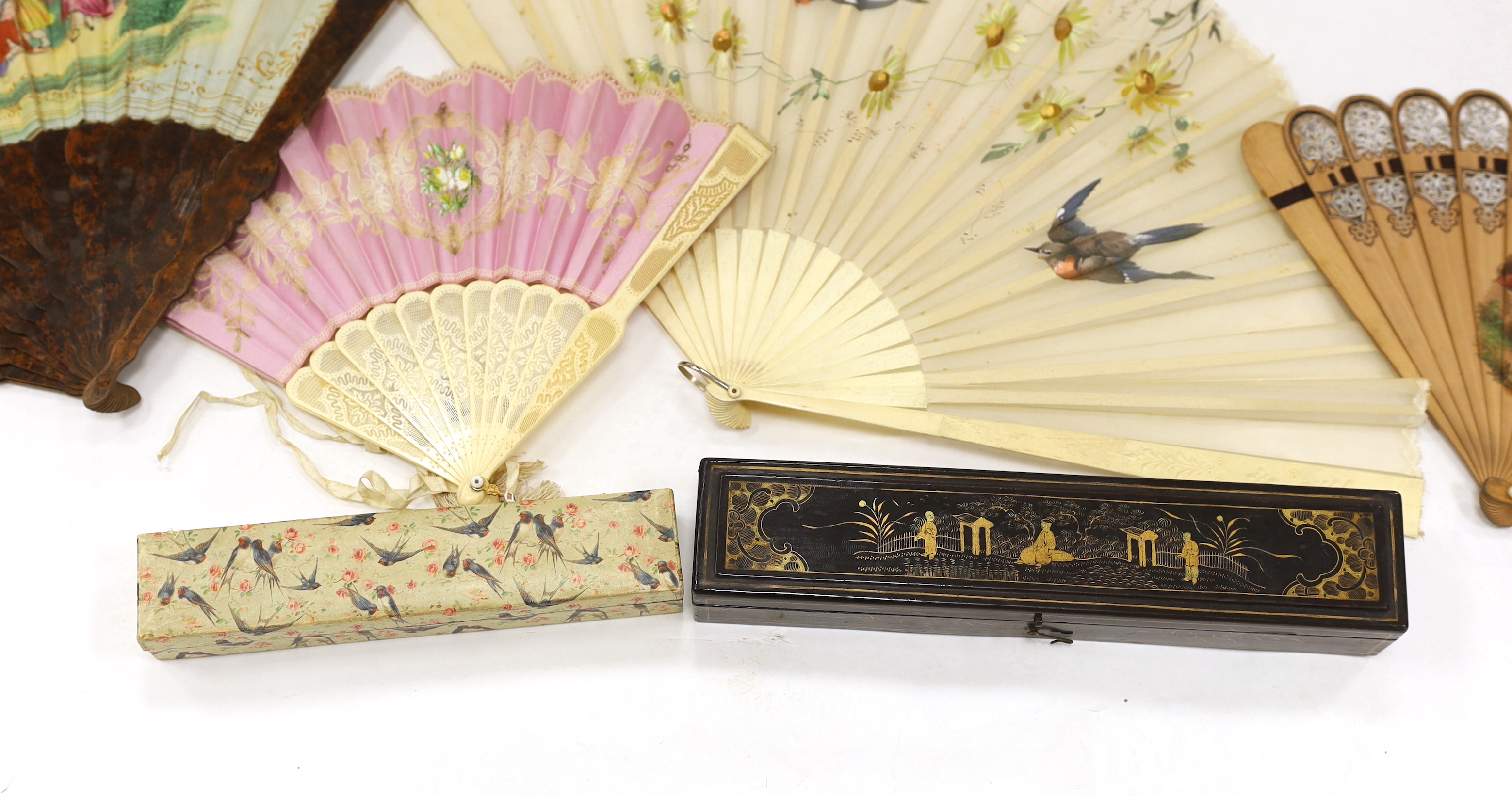 A Chinese lacquer fan box and a paper covered fan box, two Victorian fans painted with scenes of children playing, a gauze painted fan and another with bobbin lace appliqué, lacquer box 32cm wide x 4.5cm high